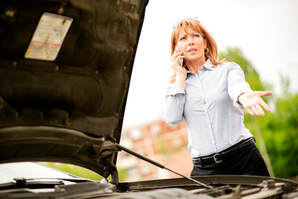 Frustrated lady calling for roadside assistance.