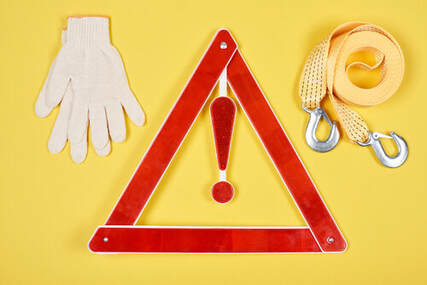 car towing gloves, rope and sign